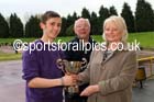 Michael Wilson (Sunderland) receives the Jimmy Hedley 800 metres Cup from Diane Holmes, daughter of the late Jimmy Hedley and Chris Betts, North Eastern Grand Prix, Monkton Stadium, Jarrow. Photo: David T. Hewitson/Sports for All Pics